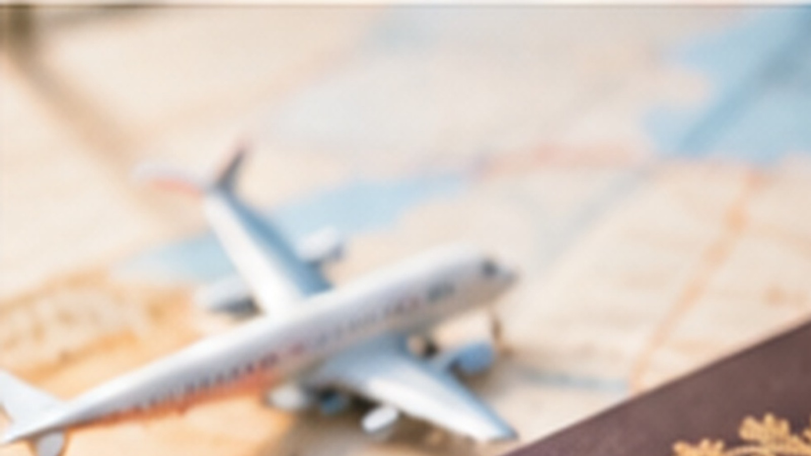 Toy airplane on a travel map prepared for a child's international journey from Portugal.